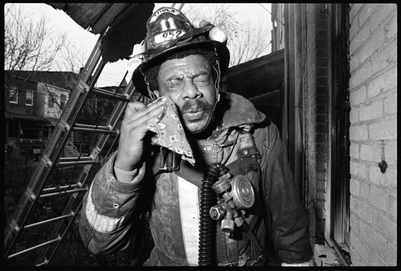 Truck 11 Firefighter Jimmie Hayes removes glass from eye, Fire, Riggs Avenue